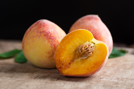 Ripe peaches on wooden tropical fruit Stock Photo