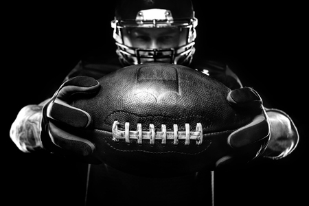 Sport concept american football sportsman player on black background sport concept