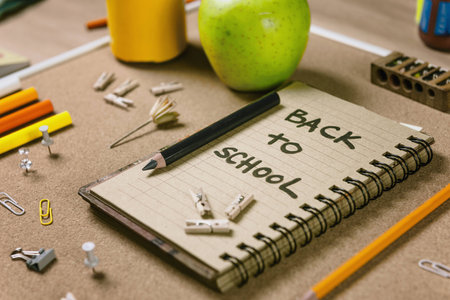 Horizontal composition with school supplies recycle paper notebook green apple sharpener and colored pencils back to school concept Stock Photo