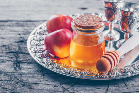 Honey jar and apples on beautiful tray on wooden table background jewish holiday rosh hashanah concept Stock Photo