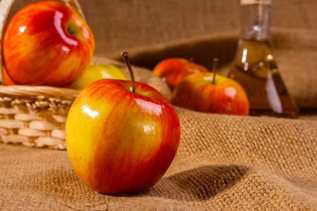 Apple vinegar on a wooden rustic background Stock Photo