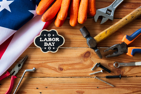 Usa labor day concept first monday in september different kinds on wrenches handy tools america flag and wooden tag on wooden table