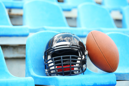 Rugby helmet with ball on stadium chair