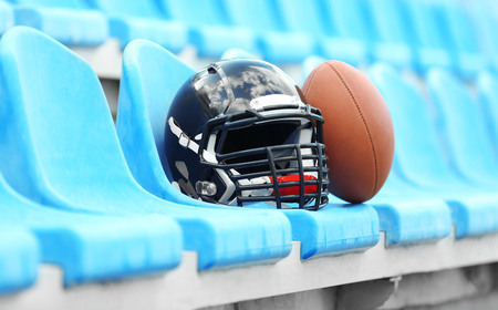 Rugby helmet with ball on stadium chair