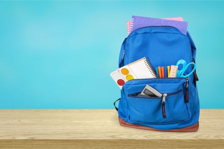 Purple backpack with school supplies isolated on white Stock Photo