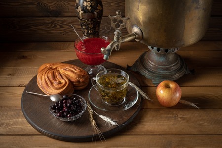 Breakfast tea from a samovar with a cheesecake jam and berries Stock Photo