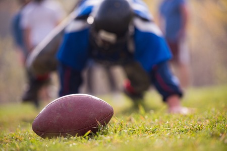 Young american football player in action during the training at field