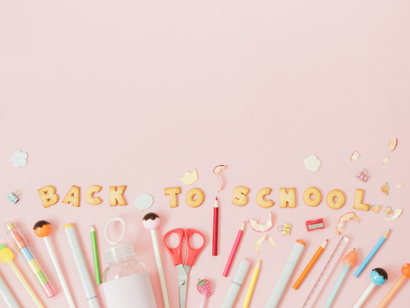 Colorful background with lettering back to school made of cookies on pink pastel background school concept Stock Photo