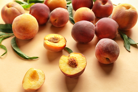 Fresh peaches on color background