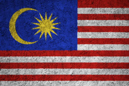 Malaysia flag on the grunge concrete wall