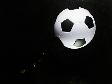 Soccer ball small on black background top view