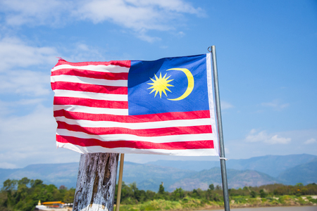 Asian flag on blue sky background with meakong river