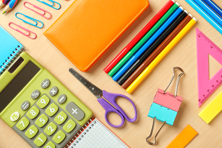 Composition with different school stationery and calculator on wooden background Stock Photo