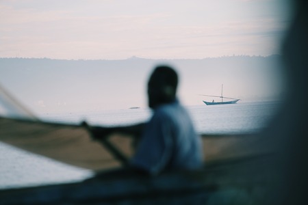 African men sitting in the boat males working fishing business of local people in africa