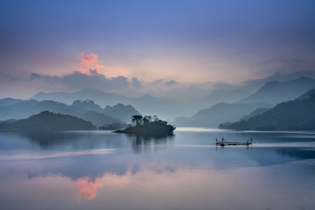 Fantastic clouds and sunset sky peaceful time colorful sky reflecting in the lake silhouette summer is coming beautiful peaceful scenery of mountain forest in th lam commune t quang province vn