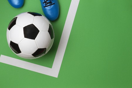 Soccer football player kick soccer ball on green background