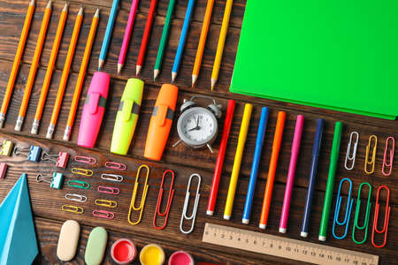 Flat lay composition with school supplies on wooden background Stock Photo