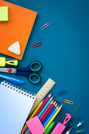 School supplies on blue background top view copy space