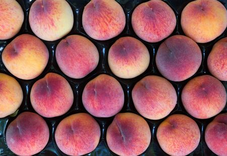 Image of peaches in boxes outdoor