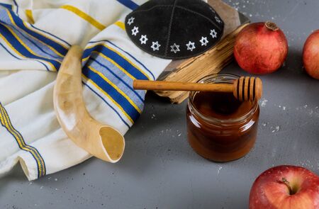 Apples pomegranate and honey for rosh hashanah jewish holiday torah book kippah a yamolka talit Stock Photo