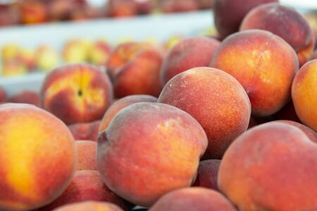 Fresh raw ripe juicy sweet peaches sold on outdoor market farm seasonal spanish fruits and vegetables Stock Photo