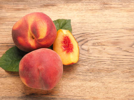 Tasty organic peaches on a wooden table healthy food concept