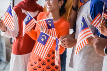 People holding malaysia flag celebrating independence day Stock Photo