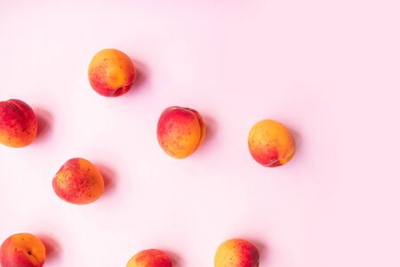 Fresh summer fruit flat composition of sweet juicy peaches on pink background Stock Photo