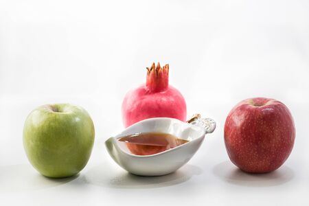 Honey bowl with apples and pomegranate on wooden white table with copy space for jewish new year holiday rosh hashanah Stock Photo