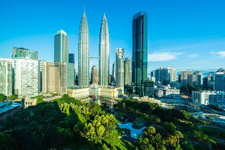 Beautiful architecture building exterior city in kuala lumpur skyline with white cloud and blue sky Stock Photo