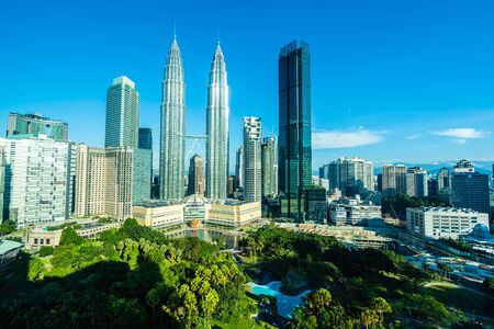 Beautiful architecture building exterior city in kuala lumpur skyline with white cloud and blue sky