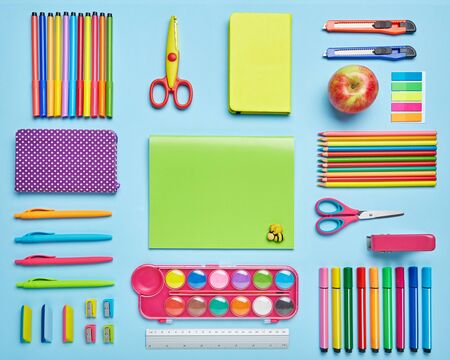 Bright stationery is laid out on a blue background stationery with copyspace top view flat lay copyspace Stock Photo