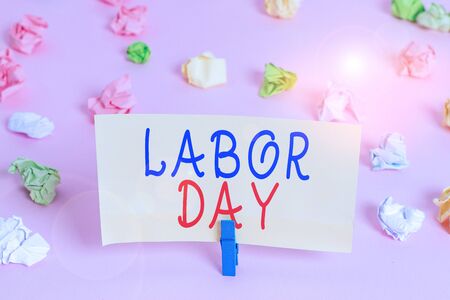 Word writing text labor day business photo showcasing an annual holiday to celebrate the achievements of workers colored crumpled papers empty reminder pink floor background clothespin