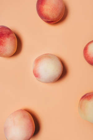 A few peaches on a pastel background flat lay top view