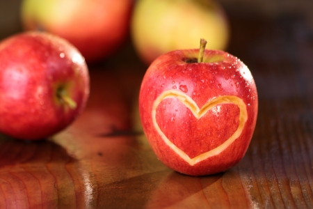 Apple heart on a wet table in the sun Stock Photo