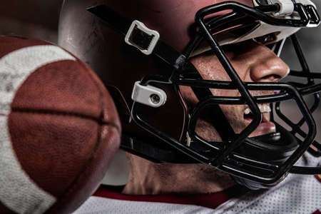 American football sportsman player on stadium with lights on background Stock Photo