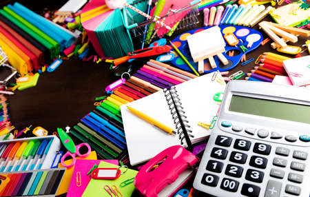 School supplies set of colorful school accessories isolated on the brown table top view