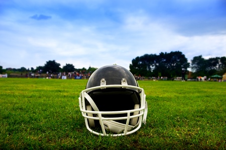 American football helmet in grass Stock Photo