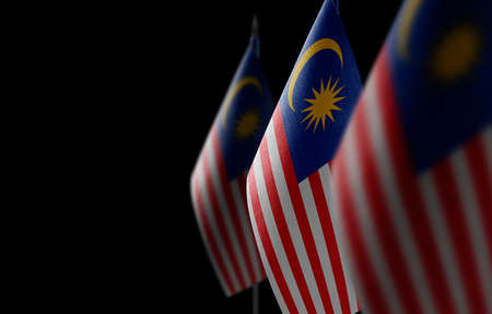 Small national flags of the malaysia on a black background