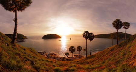 Panorama of tropical coast with beach palm trees and island in calm blue sea nai harn beach area of phuket thailand