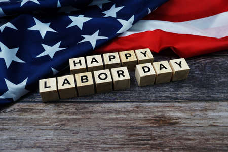 Happy labor day word alphabet letters with usa flag on wooden background