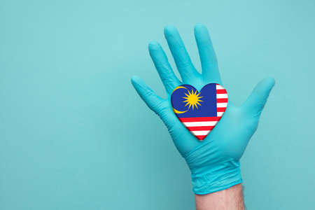 Malaysia medical health heart nurse hand holding country heart flag