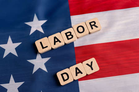 Top view of wooden cubes with labor day lettering on usa flag Stock Photo