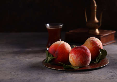 Fresh organic fruit peaches on a plate still life