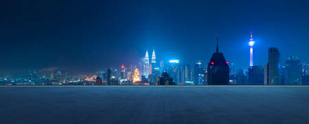 Panoramic view of empty concrete tiles floor with city skyline night scene