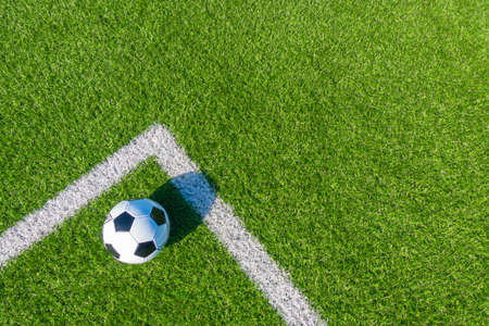 Soccer football sport background soccer ball on green artificial grass turf field with white line top view Stock Photo