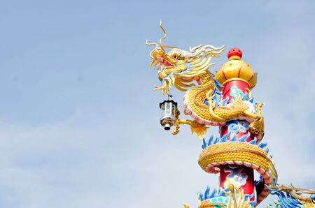 Golden chinese dragon with sky background