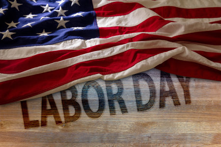 Labor day text and usa flag on wooden table above view united states holiday celebration background