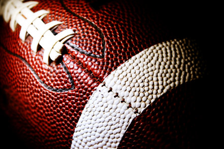 Close up of an american football against a black background Stock Photo