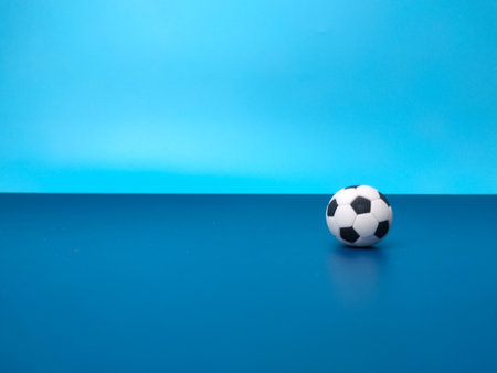 A ball is on a blue background with copy space for text Stock Photo